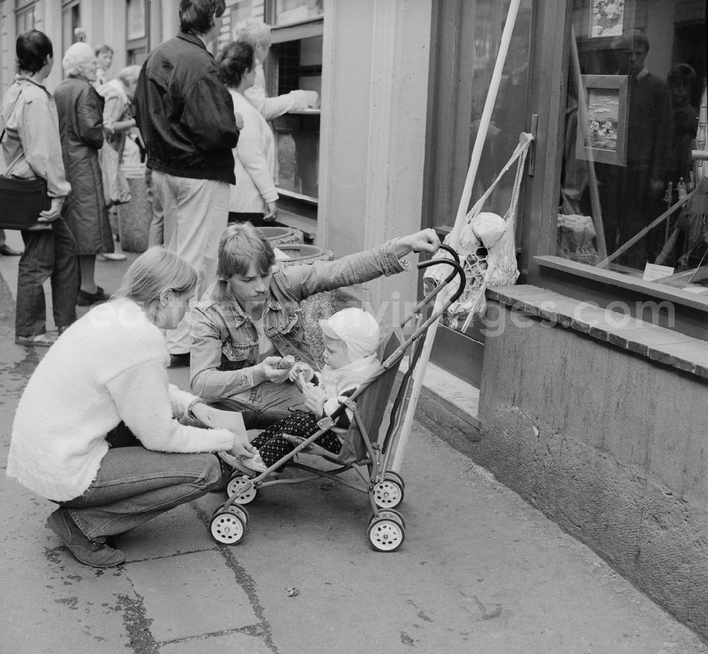 Zittau: Young Family with a stroller in Zittau in the state Saxony on the territory of the former GDR, German Democratic Republic