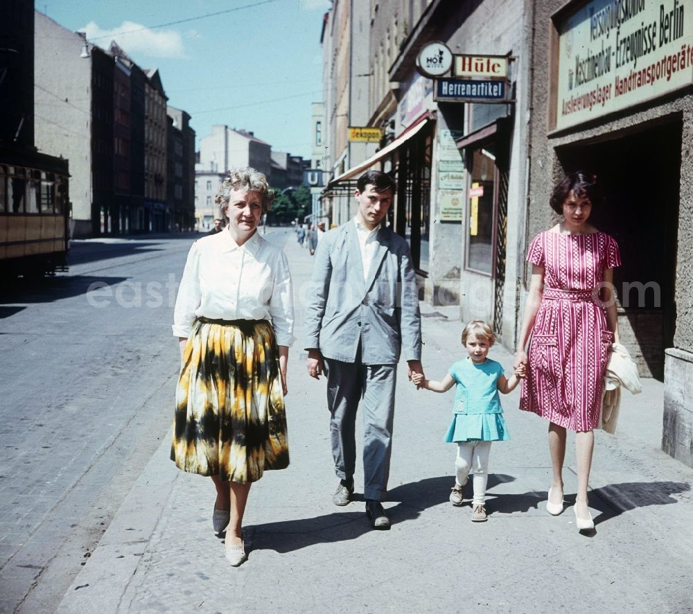 GDR picture archive: Berlin - A young family strolls along Weinmeister street, near subway station Weinmeister street in Berlin, the former capital of the GDR, German democratic republic