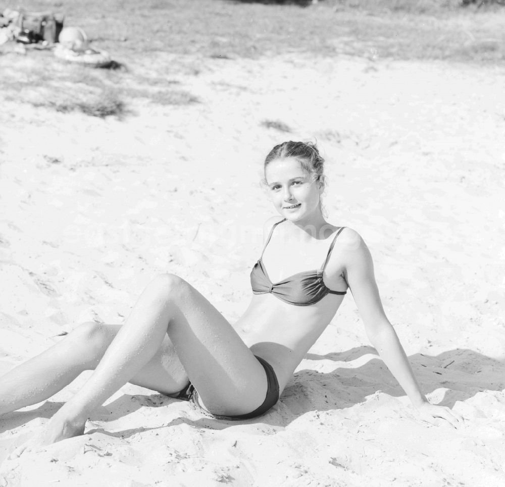 GDR photo archive: Grünheide (Mark) - Young woman wearing a bikini on a sandy beach in Gruenheide (Mark) in Brandenburg in the area of the former GDR, German Democratic Republic