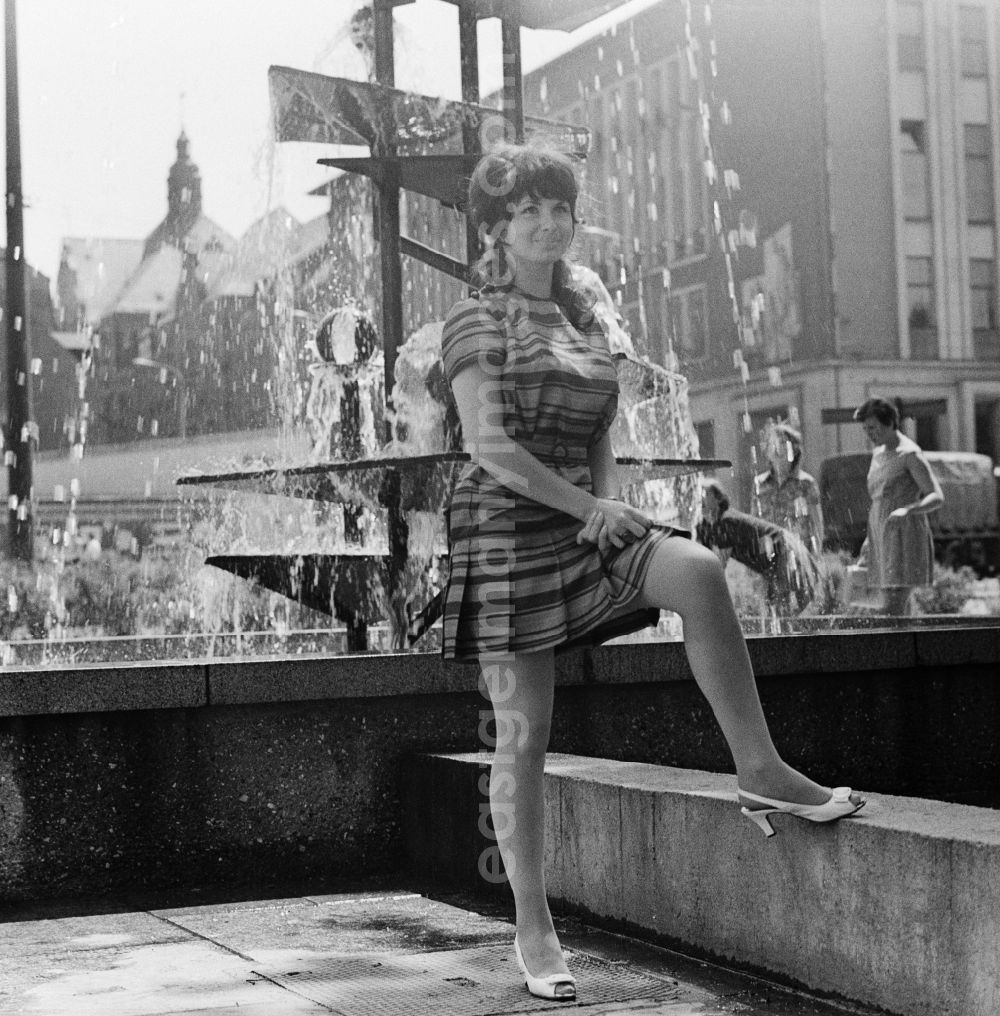 GDR picture archive: Chemnitz - Young woman posing in front of the fountain collapse in Chemnitz in Saxony today