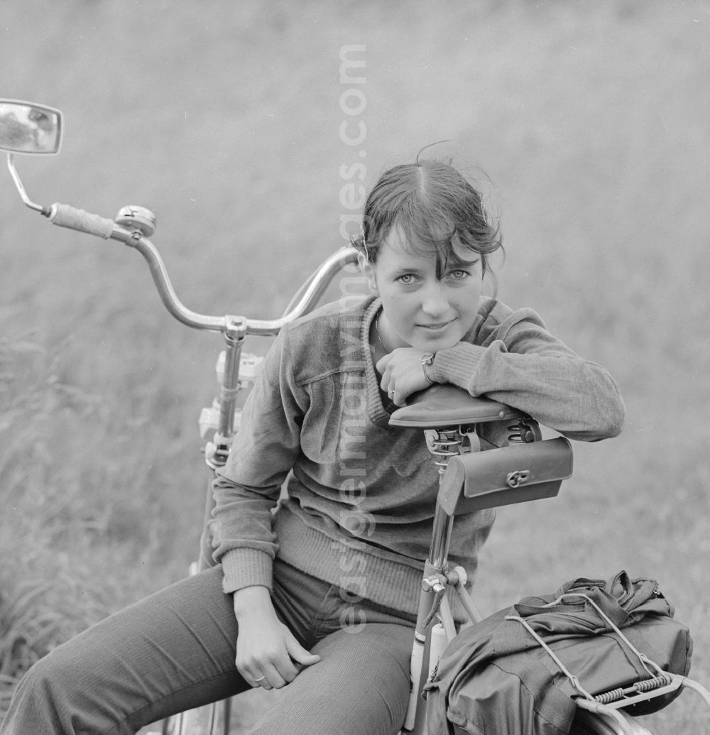 GDR image archive: Hohen Neuendorf - Young woman sitting on a bicycle in Hohen Neuendorf in Brandenburg today
