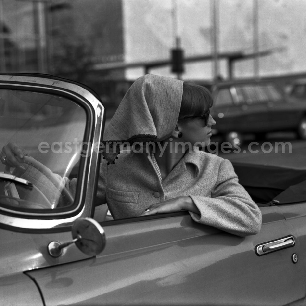 GDR photo archive: Berlin - Young woman as a driver at the steering wheel of a car SKODA FELICIA Cabriolet in Berlin, the former capital of the GDR, German Democratic Republic