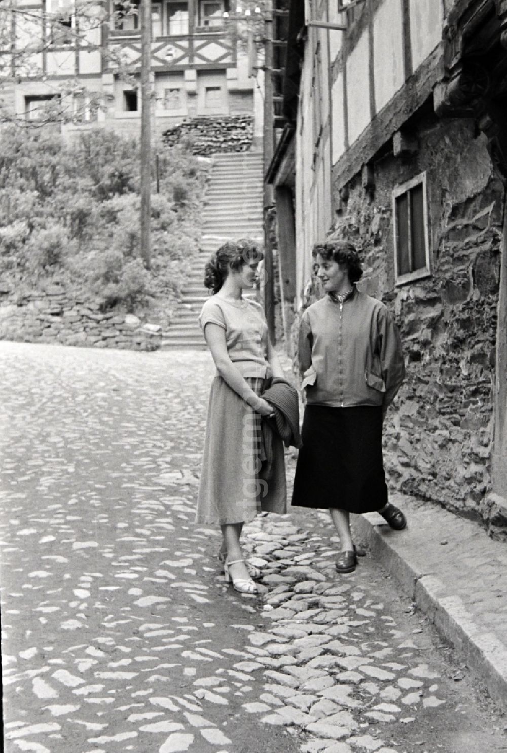 GDR photo archive: Stolberg (Harz) - Fashion and clothing of street passers-by young women in Stolberg (Harz) in the state Saxony-Anhalt on the territory of the former GDR, German Democratic Republic