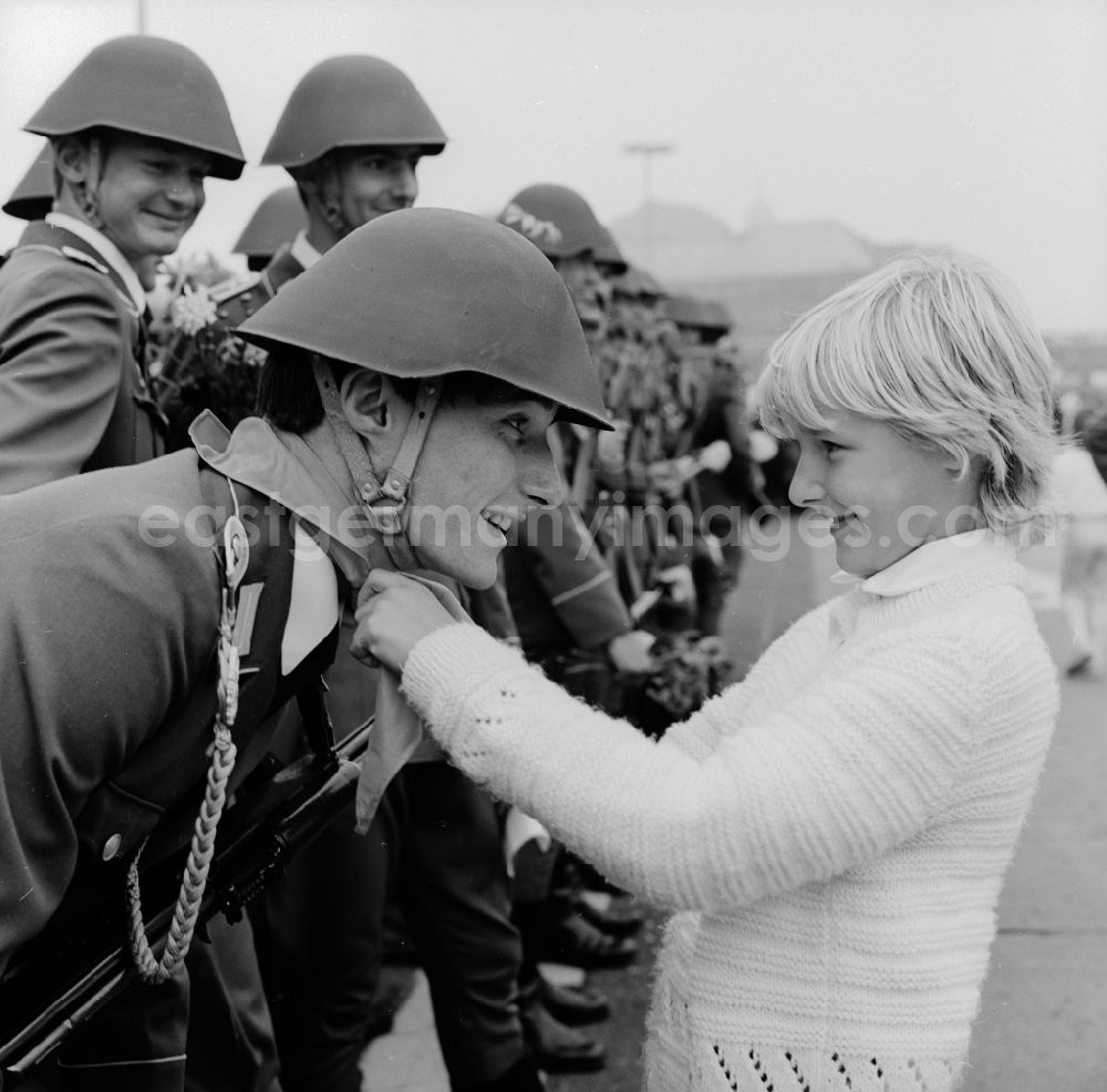 GDR picture archive: Berlin - Young pioneers present NVA soldiers with flowers and scarves in Berlin, the former capital of the GDR, German Democratic Republic