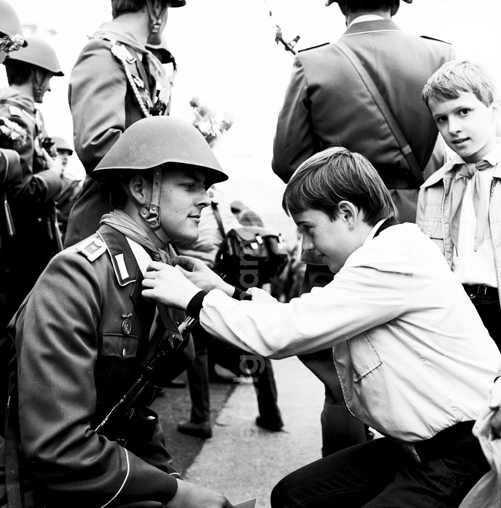 GDR image archive: Berlin - Young pioneers present NVA soldiers with flowers and scarves in Berlin, the former capital of the GDR, German Democratic Republic
