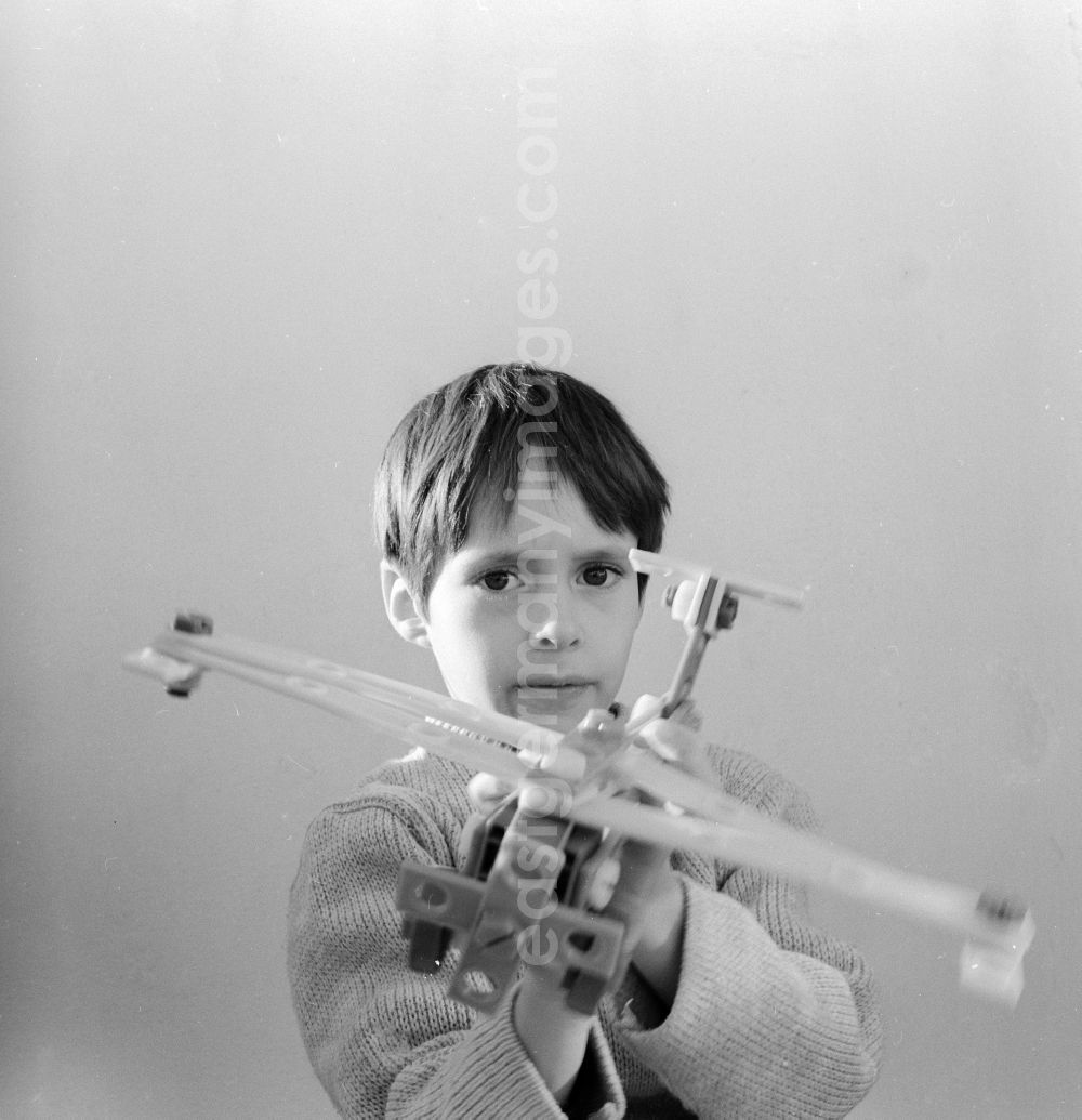 Berlin: A boy plays with an airplane made of plastic parts in Berlin, the former capital of the GDR, German Democratic Republic