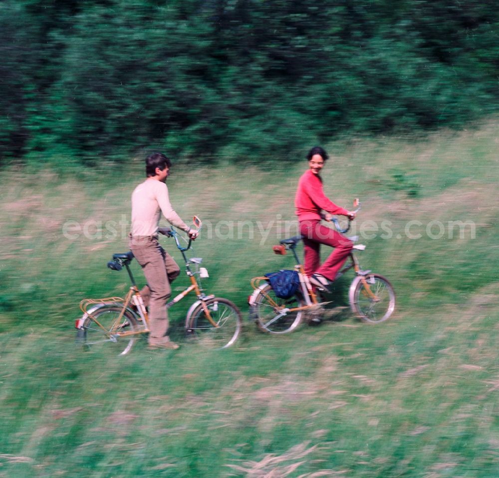 GDR image archive: Hohen Neuendorf - Young couple on folding bikes on the road in the countryside in Hohen Neuendorf in Brandenburg today
