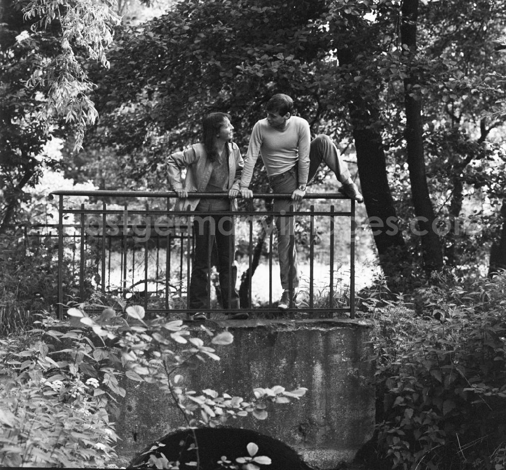 GDR photo archive: Hohen Neuendorf - Young couple standing on a bridge in Hohen Neuendorf in Brandenburg today