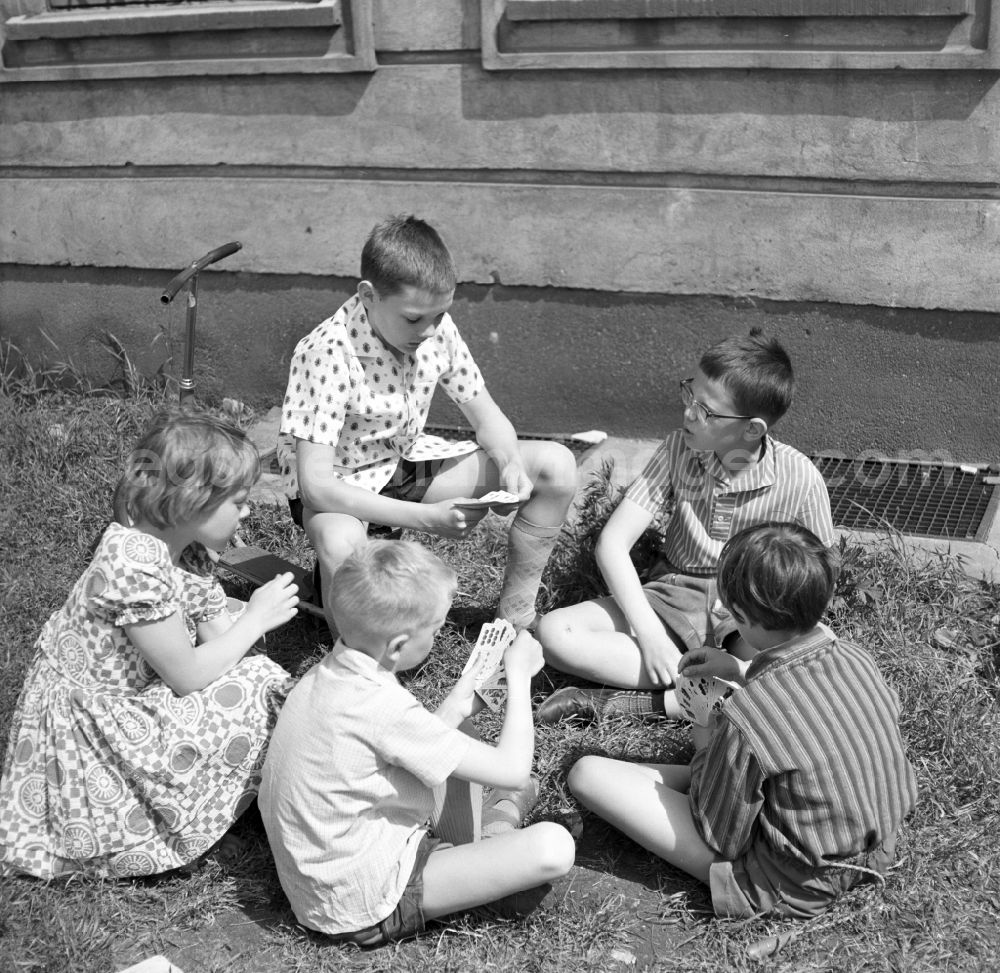 GDR photo archive: Magdeburg - Children playing cards outdoors in Magdeburg