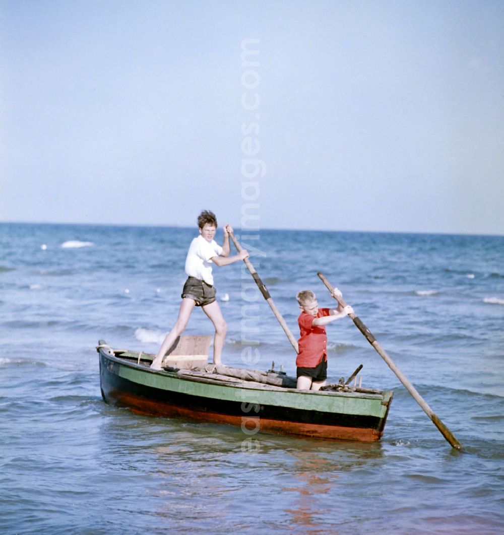 Rostock: Two children on a boat at the Baltic Sea in Rostock in the state Mecklenburg-Western Pomerania on the territory of the former GDR, German Democratic Republic