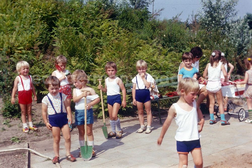 GDR image archive: Bernau bei Berlin - Children play in the garden of a daycare center in Bernau near Berlin in the state of Brandenburg on the territory of the former GDR, German Democratic Republic