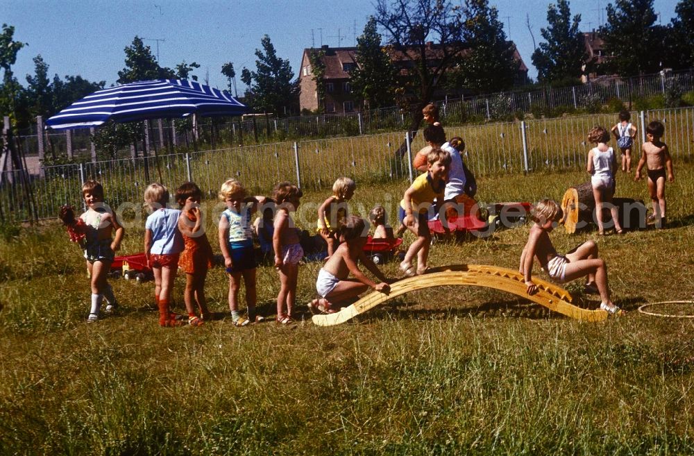GDR photo archive: Bernau bei Berlin - Children play in the garden of a daycare center in Bernau near Berlin in the state of Brandenburg on the territory of the former GDR, German Democratic Republic
