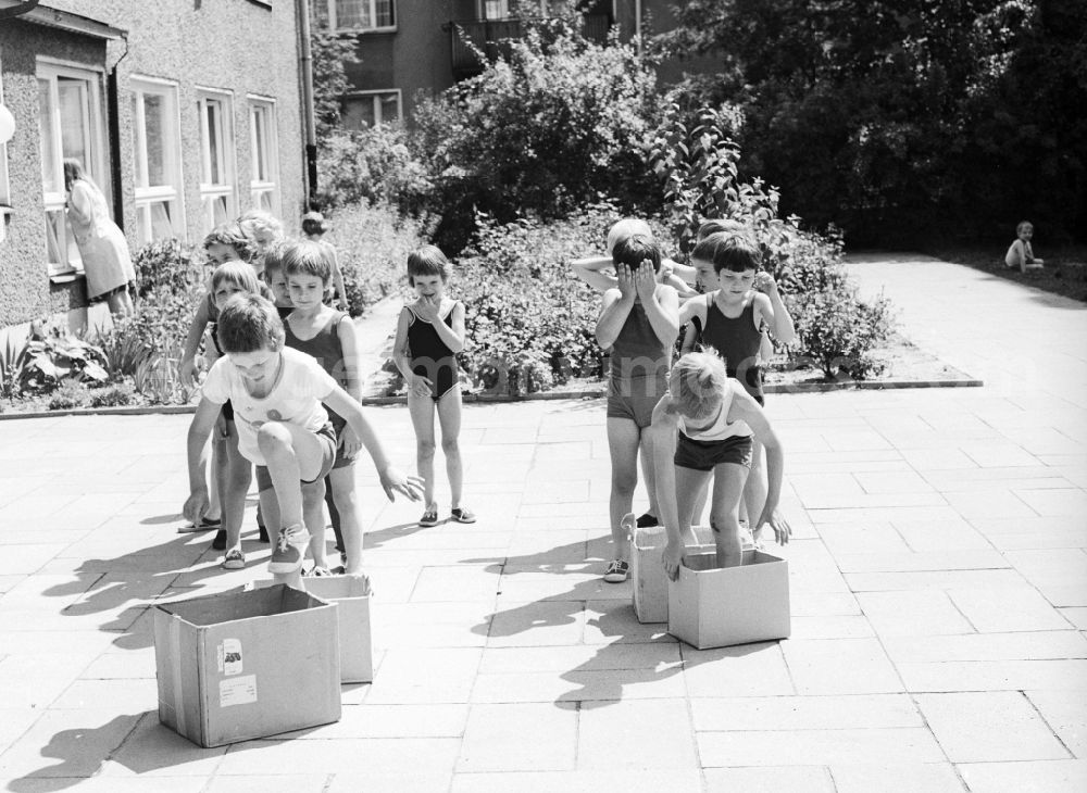 Berlin: Children celebrate the International Children's Day at a preschool in Berlin, the former capital of the GDR, German Democratic Republic. On this day there was always a festive program which consisted of sport and play. Here at the box steeplechase