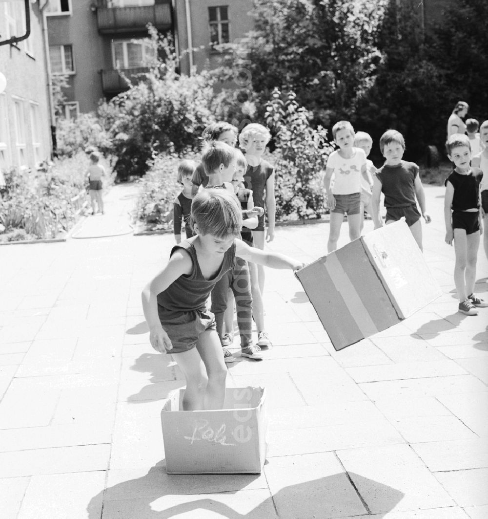 GDR image archive: Berlin - Children celebrate the International Children's Day at a preschool in Berlin, the former capital of the GDR, German Democratic Republic. On this day there was always a festive program which consisted of sport and play. Here at the box steeplechase