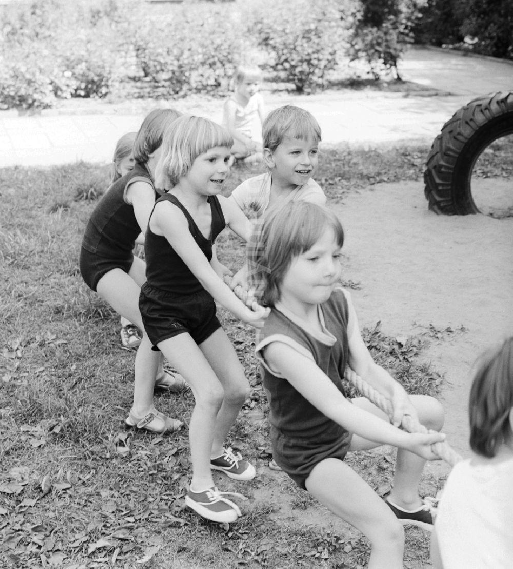 GDR picture archive: Berlin - Children celebrate the International Children's Day at a preschool in Berlin, the former capital of the GDR, German Democratic Republic. On this day there was always a festive program which consisted of sport and play. Here the tug