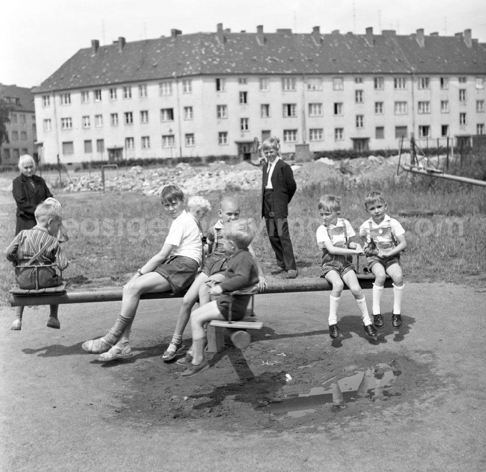 GDR picture archive: Magdeburg - A couple children sitting on a carousel in a playground in Magdeburg