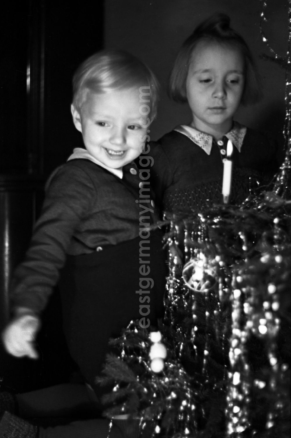 GDR image archive: Merseburg - Children stand beaming before the Christmas tree in Merseburg in the federal state Saxony-Anhalt in Germany