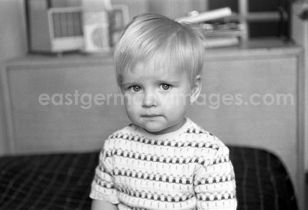 Berlin - Friedrichshain: A little blond boy with knit sweater in Berlin - Friedrichshain