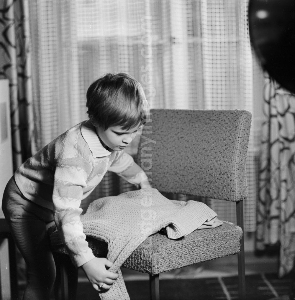 GDR photo archive: Berlin - Small child when put together a sweater in Berlin