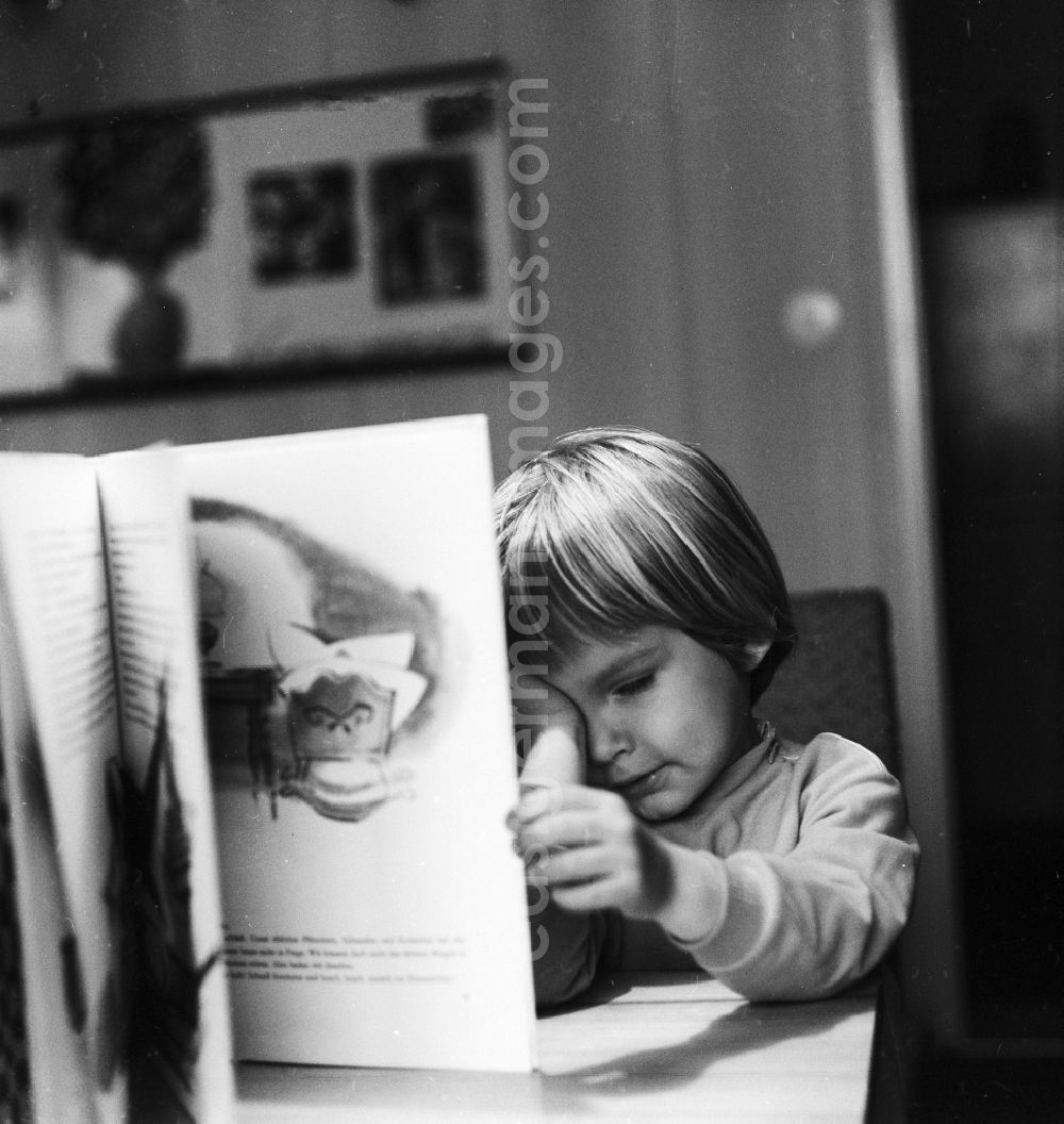 Berlin: Small child reading a book in Berlin