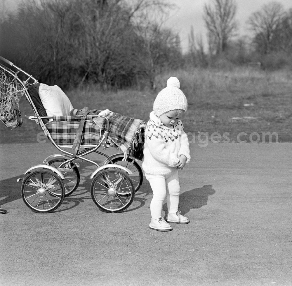 GDR image archive: Magdeburg - Small child with bobble hat is on his stroller in Magdeburg