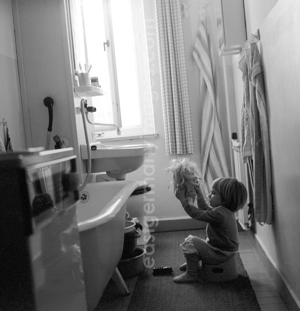 GDR photo archive: Berlin - Small child sits in the bathroom on his potty in Berlin