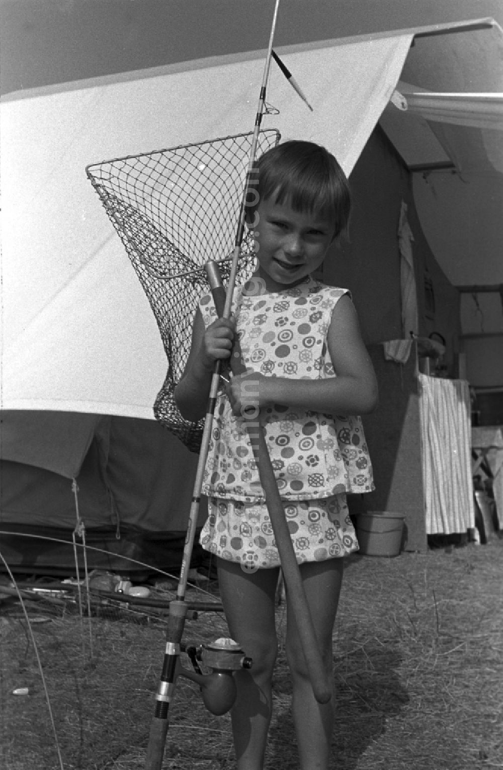 GDR picture archive: Neuruppin OT Stendenitz - A little girl with fishing rod and landing net in front of a tent in Brandenburg