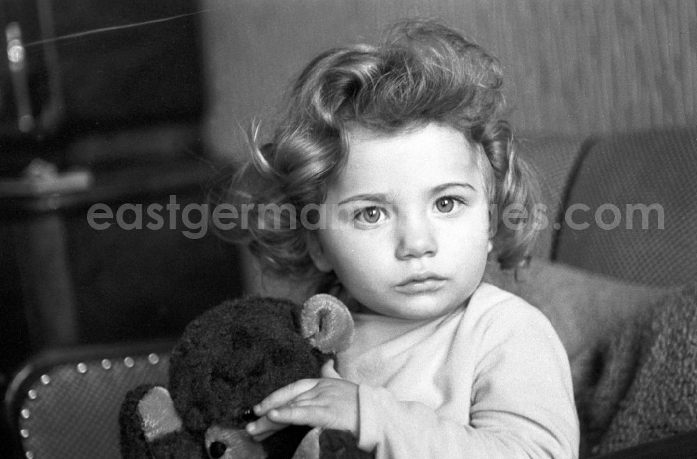 Berlin - Friedrichshain: A little girl with curly hair and Teddy Bear in Berlin - Friedrichshain