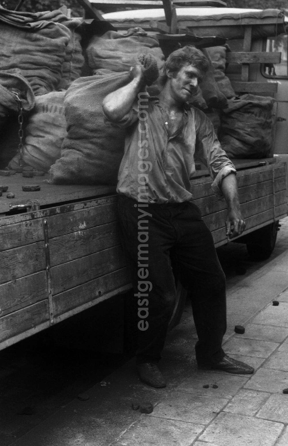 GDR image archive: Berlin - Worker carries a sack of carbon in the district Mitte in Berlin Eastberlin on the territory of the former GDR, German Democratic Republic