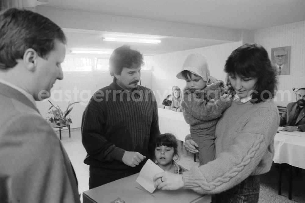 GDR image archive: Berlin - A young family with two small children standing at the ballot box at the polling station to the municipal elections in the GDR, in Berlin, the former capital of the GDR, the German Democratic Republic