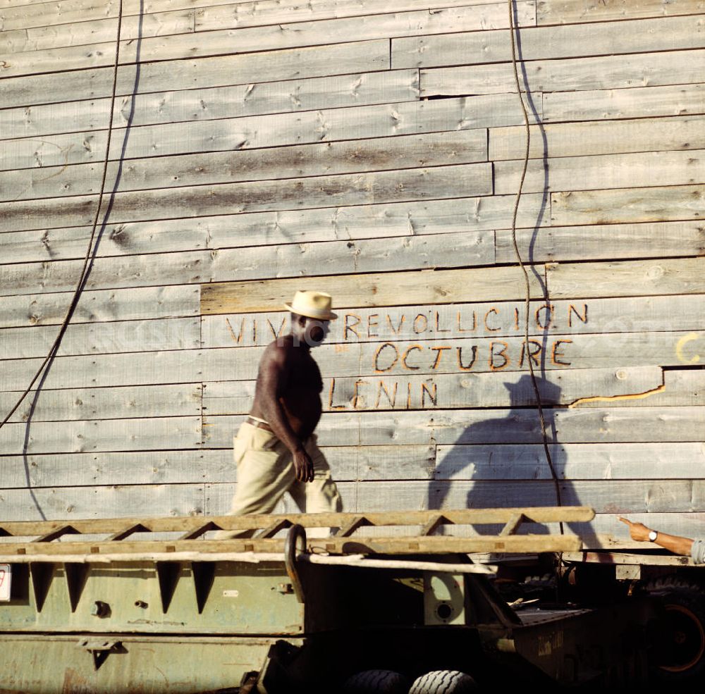 GDR image archive: Cienfuegos - Arbeiter in einer Düngemittelfabrik in Cienfuegos. An der Bretterwand steht die Aufschrift Viva Revolucion Octubre Lenin. In den 60er und 7