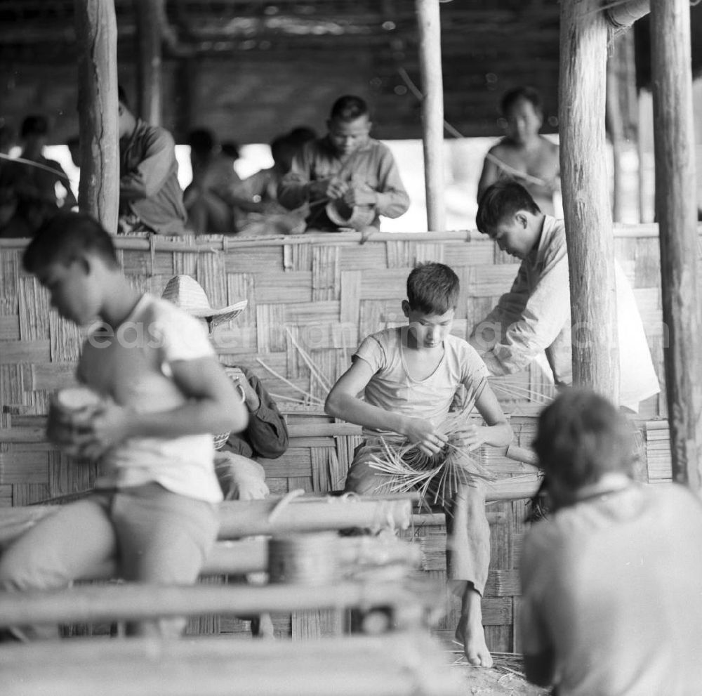 GDR picture archive: Ang Nam Ngum - Männer auf der Männerinsel Don Thao im Nam-Ngum-Stausee in der Demokratischen Volksrepublik Laos. Das Nam Ngum Reservoir entstand mit der Fertigstellung des gleichnamigen Staudamms im Jahr 1971. Die im See liegenden Inseln dienten in den 7