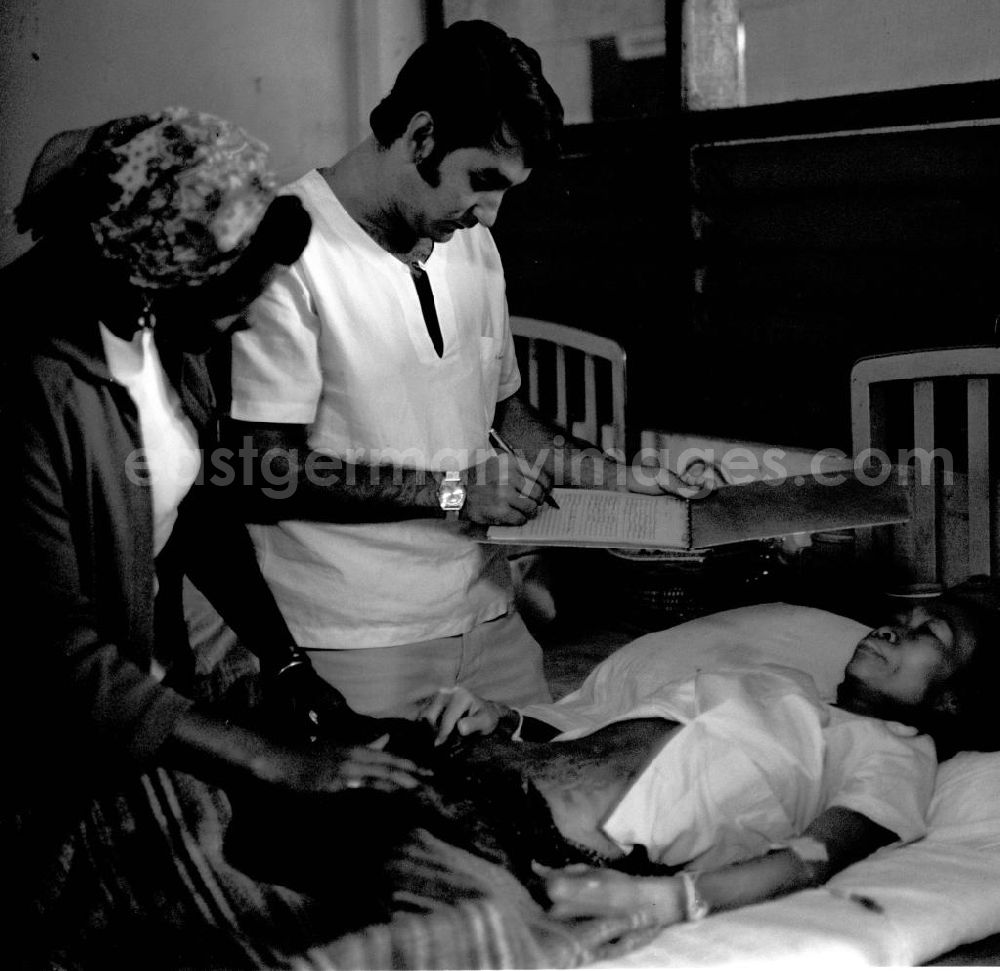 GDR picture archive: Vientiane - Ein kubanischer Arzt kümmert sich um eine laotische Patientin in einem laotischen Krankenhaus in der Demokratischen Volksrepublik Laos.