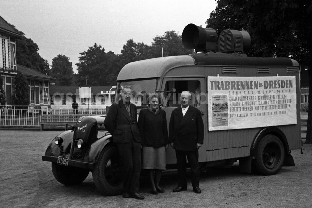 Dresden: People standing in front of a Granit 25 loudspeaker truck at the Dresden-Seidnitz racecourse after in Dresden in the state Saxony on the territory of the former GDR, German Democratic Republic