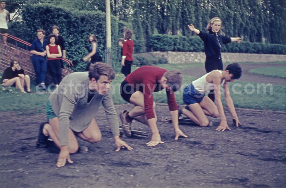 GDR photo archive: Berlin - Students during physical education lessons as part of vocational training on a sports field in the Treptow district of Berlin East Berlin in the territory of the former GDR, German Democratic Republic