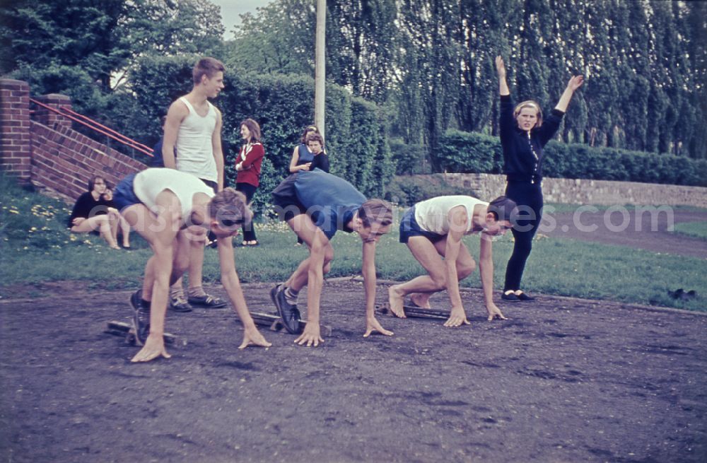 GDR picture archive: Berlin - Students during physical education lessons as part of vocational training on a sports field in the Treptow district of Berlin East Berlin in the territory of the former GDR, German Democratic Republic