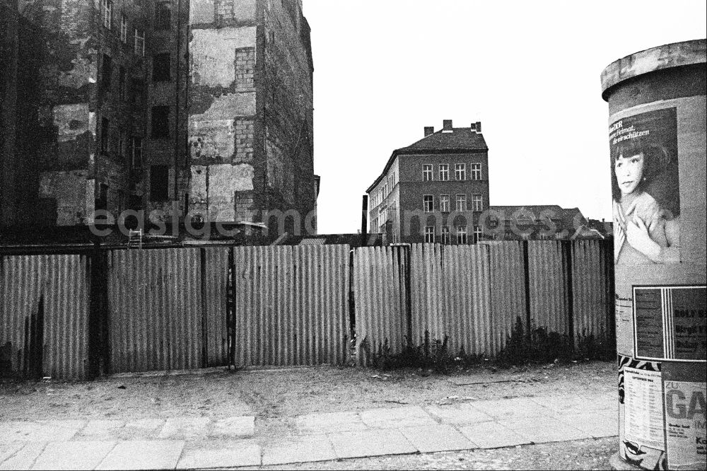 GDR picture archive: Berlin - Advertising as a contrast to the dilapidated reality in the old residential area on the Scheunenviertel on an advertising pillar on a sidewalk on Max-Beer-Strasse in the Mitte district of Berlin East Berlin in the area of the former GDR, German Democratic Republic