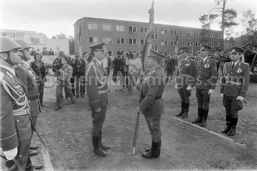 GDR picture archive: Goldberg - Return of the troop flag before the parade formation and march of soldiers and officers of Panzer Regiment 8 (PR-8) on the occasion of the ceremonial and media-effective dissolution of the troop unit on the grounds of the Artur-Becker barracks in Goldberg in the state of Mecklenburg-Western Pomerania on the territory of the former GDR, German Democratic Republic