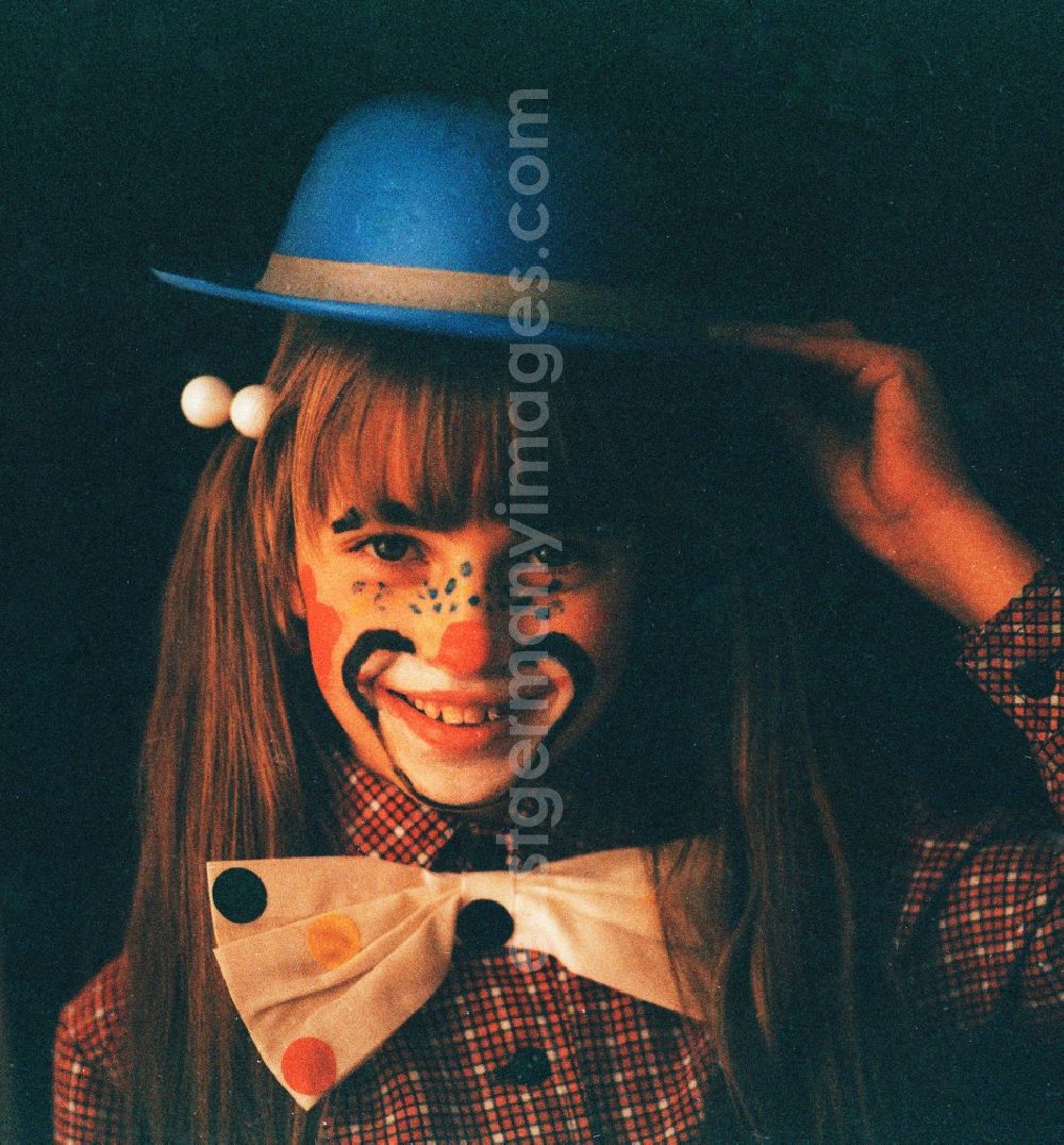 Berlin: Girl with hat painted as a clown for carnival in Portrait in Berlin