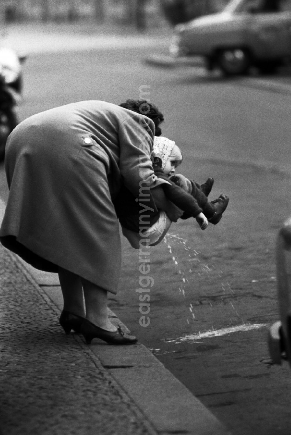 Berlin: Girl pees on the street in East Berlin in the area of the former GDR, German Democratic Republic