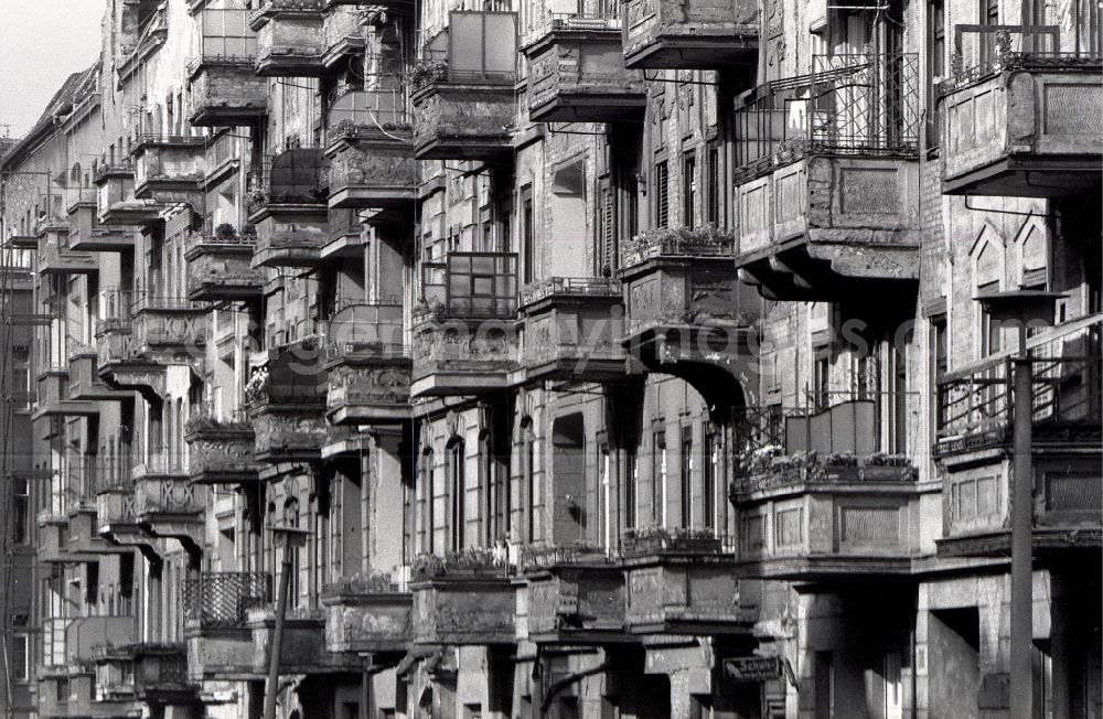 GDR photo archive: Berlin - Street view of an apartment building - building front with decaying balconies in need of refurbishment in the district Gleimviertel in Berlin Eastberlin on the territory of the former GDR, German Democratic Republic
