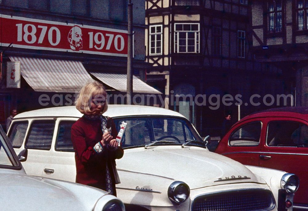 Memleben: Woman standing next to a Skoda car in Memleben in the state Saxony-Anhalt on the territory of the former GDR, German Democratic Republic