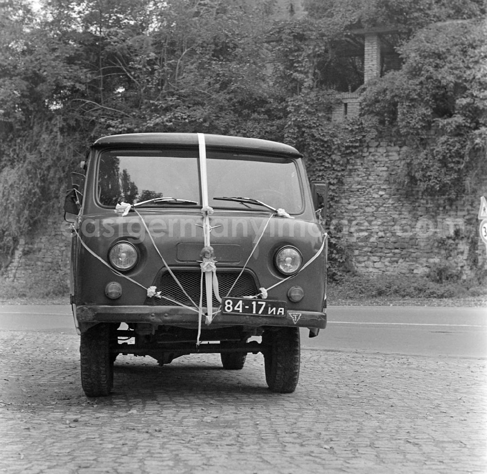 GDR picture archive: Potsdam - Minibus military vehicle UAZ 453 with wedding decorations on a parking lot at the historic mill in Potsdam in the state Brandenburg in the area of the former GDR, German Democratic Republic