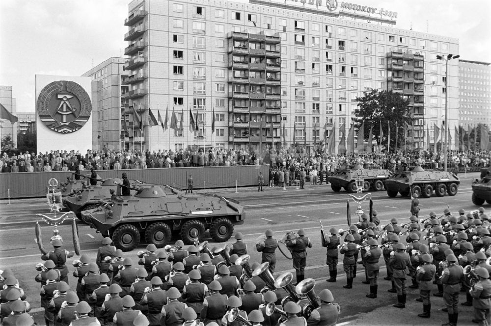 GDR picture archive: Berlin - Parade formation and march of soldiers and officers on the parade of honour with motorised land forces units including tanks of the NVA National People's Army in Karl-Marx-Allee in the Mitte district of Berlin, the former capital of the GDR, German Democratic Republic