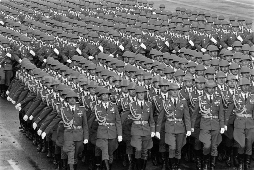 Berlin: Parade formation and march of soldiers and officers on honour parade with motorised land forces units of the NVA National People's Army in Karl-Marx-Allee in the Mitte district of Berlin, the former capital of the GDR, German Democratic Republic