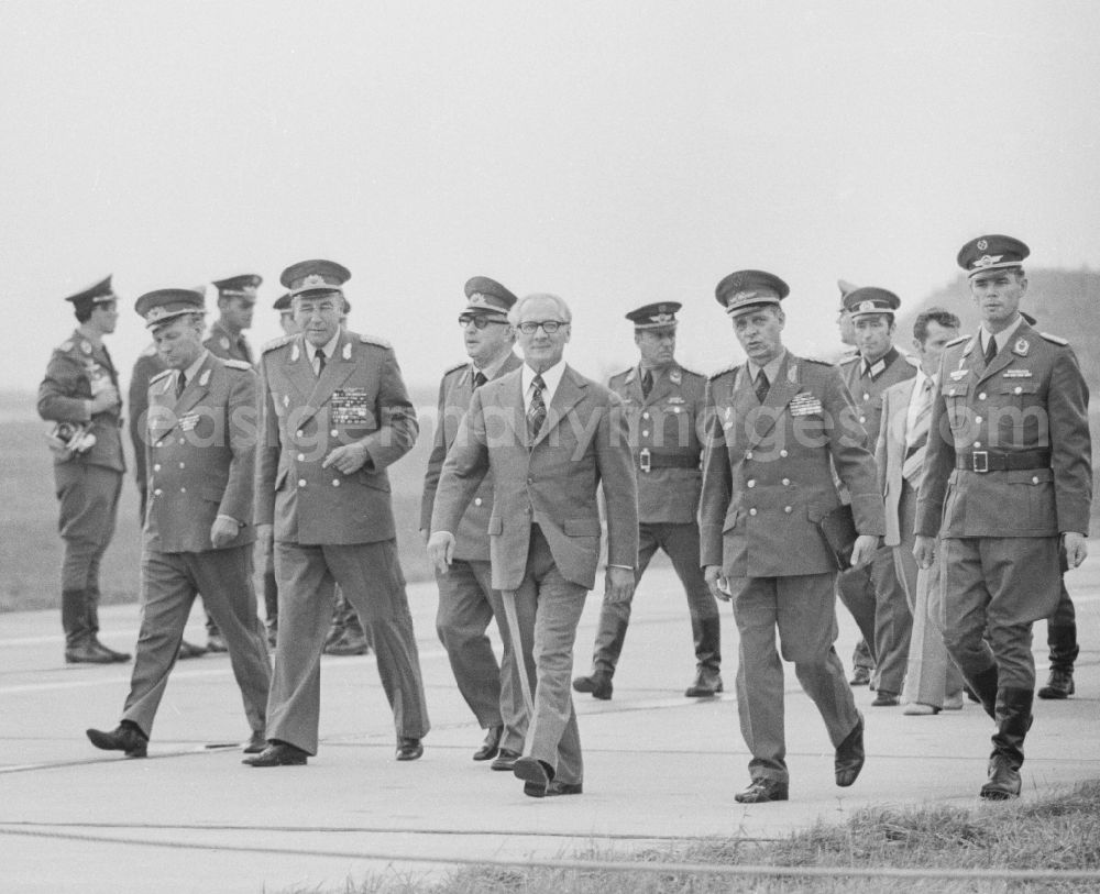 GDR photo archive: Peenemünde - Members of the Politburo of the SED Central Committee to visit the fighter wings 9 (JG-9) in Peenemuende in Mecklenburg-Western Pomerania in the field of the former GDR, German Democratic Republic. From left to right: Major Gerhard Fiss, the Deputy Minister of National Defence and Chief of the command LSK / LV Air Force / Air Defense of the NVA Wolfgang Reinhold (1923 - 2012), general secretary of the Central Committee (ZK) of the SED Erich Honecker (1912 - 1994) , the Minister of State Security Erich Emil Fritz Mielke (1907 - 2000) and army general Karl-Heinz Hoffmann (191