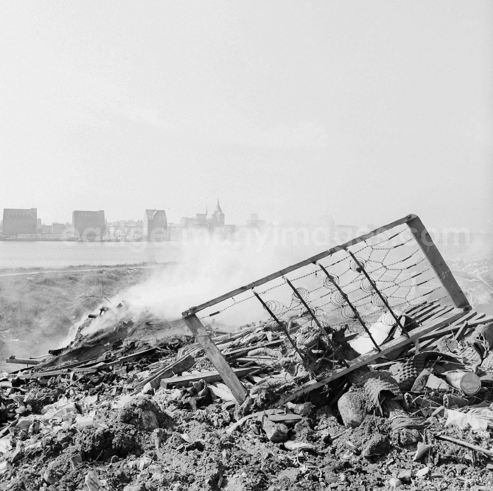 GDR photo archive: Rostock - Garbage dump on the banks of the Unterwarnow in the district Gehlsdorf in Rostock in the state Mecklenburg-West Pomerania on the territory of the former GDR, German Democratic Republic