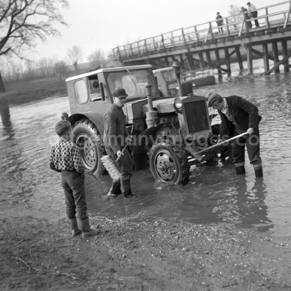 GDR photo archive: Magdeburg - Men wash their tractors in the Elbe near Magdeburg in Saxony - Anhalt
