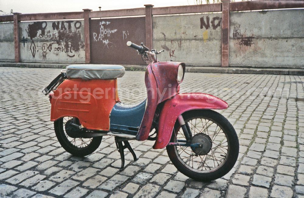 GDR picture archive: Berlin - A Simson Schwalbe KR 51 moped - made of colorful individual parts - parked in traffic on Warschauer Strasse in the Friedrichshain district of Berlin East Berlin in the area of ??the former GDR, German Democratic Republic