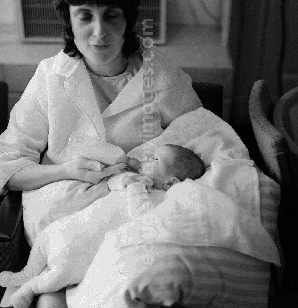 Berlin: Mother feeding baby with bottle in Berlin